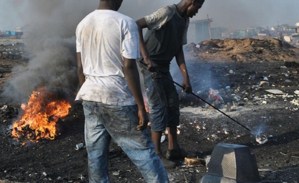 Aglogbloshie - burning off plastic to get to valuable metals. Photo: qamp.net via Flickr.