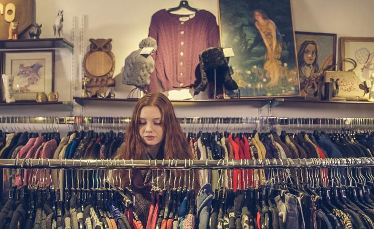 Women browses for clothes in a charity shop