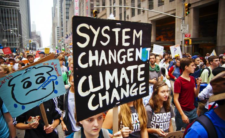 Placard reading 'system change not climate change'