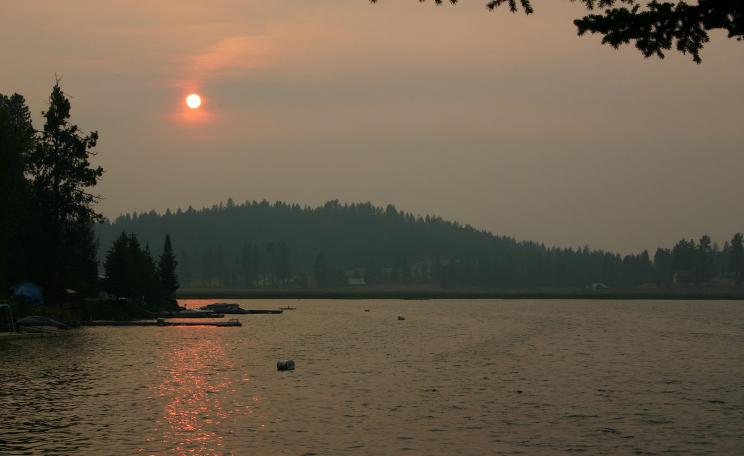Sunset over Loon Lake, Washington. Atmospheric conditions created by forest fire about 1 mile from location photo was taken.
