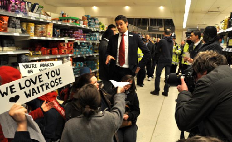 Climate Rush members protest Waitrose's relationship with Shell by occupying the store's oil aisle