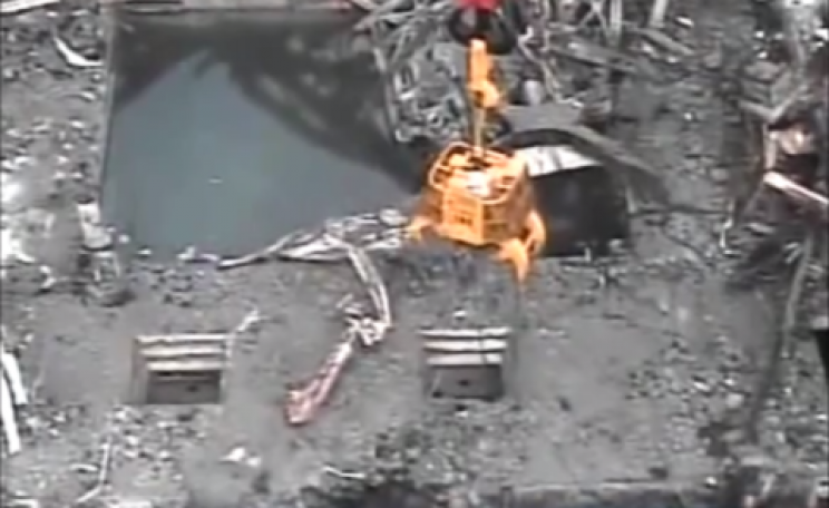 Clearing debris from around the spent fuel pond in Fukushima Building 3 in late 2013. Photo from Tepco video.