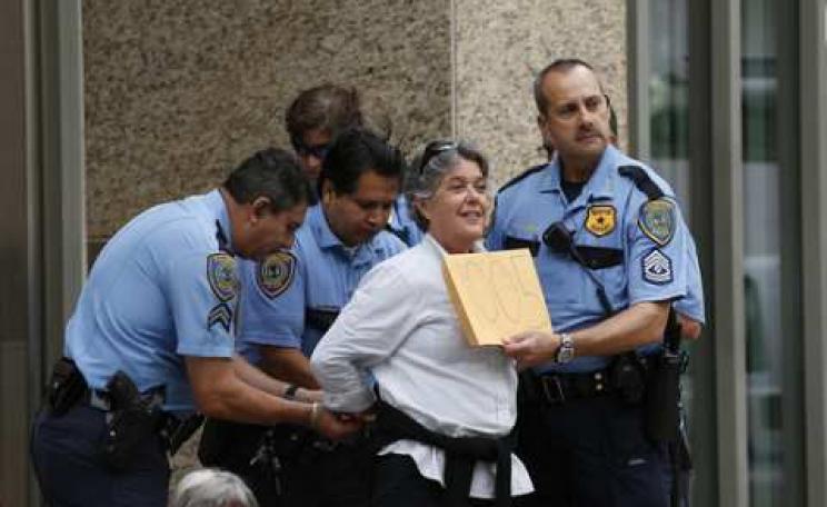 A #NoKXL activist is arrested during a sit-in outside TransCanada’s Houston offices in 2013. Photo: Aaron M. Sprecher via Flickr.