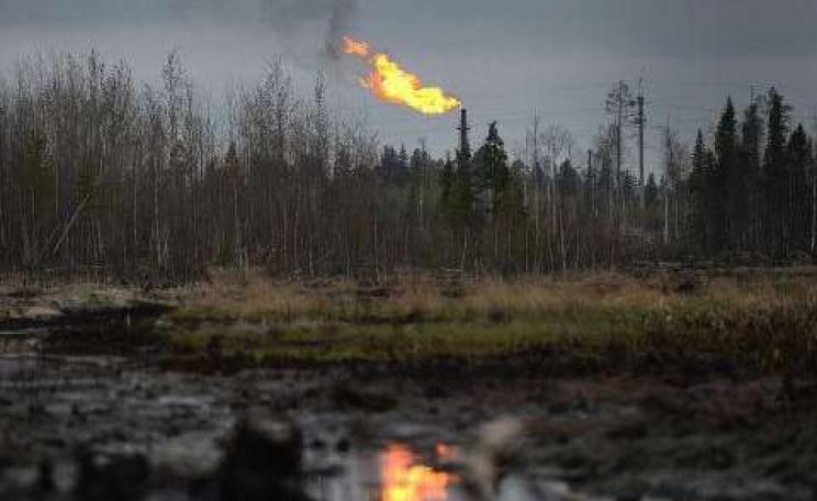 Crude oil seeps through the ground, poisoning the land the Khanty live off. Photo: &copy; RIA Novosti / Ramil Sitdikov.