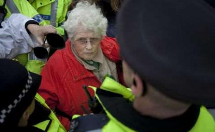 Anne Power surrounded by police at an anti-fracking protest at Barton Moss, December 2013. Photo: Steven Speed / SalfordStar.com.