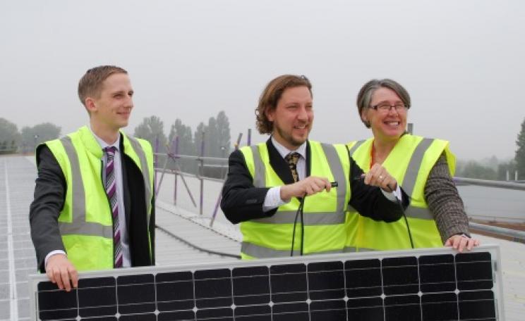 Luke Marion, installer Chris Jardine and Barbara Hammond connect the 140kW scheme's last panel, completing Oxford's biggest solar installation.