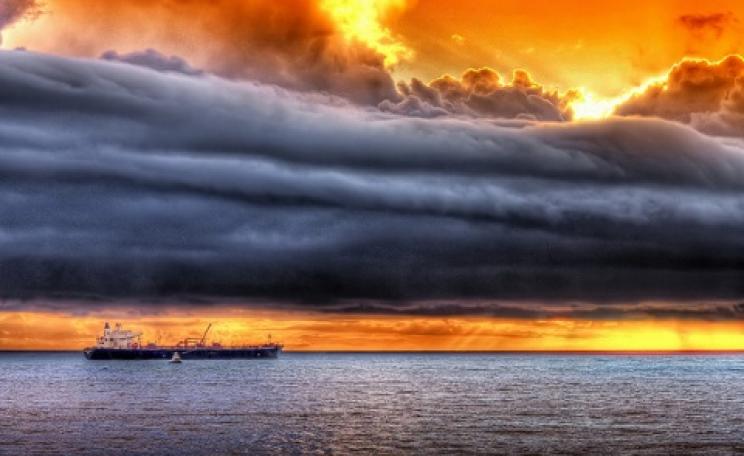 Dark clouds gather over a sunset industry - represented by a Chevron oil tanker. Photo: Jamie Grant via Flickr.