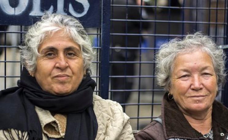 Zekiye Ozdemir and Gulseren Caliskan, both 70, maintain their daily vigil directly in front of a large iron police barrier  at the construction site on the edge of Validebag Grove, Istanbul. Photo: Nick Ashdown.
