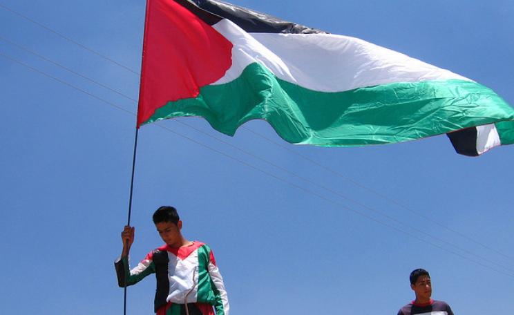 Palestinian demands for freedom and justice will never be relinquished. The Palestinian flag flying at a demonstration at Bil'in on the West Bank. Photo: Adam Walker Cleaveland.