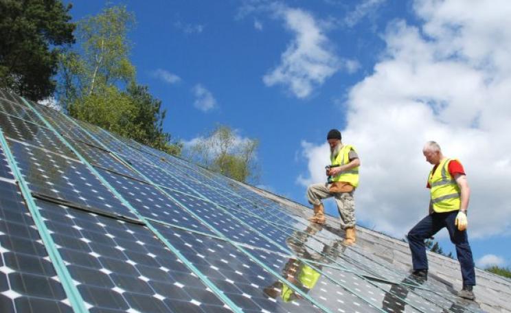 Thanks to the increasing role of solar power, electricity could soon be 'free' - at least while the sun is shining. Solar panels under installation at the Centre for Alternative Technology. Photo: CAT via Flickr (CC BY 2.0).