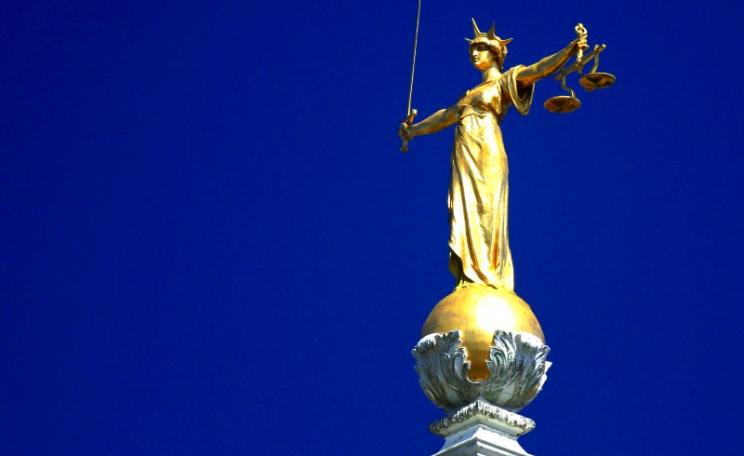 In case you didn't know, her scales are weighted. And government 'reforms' are only making them more so. The statue of Lady Justice atop England's Central Criminal Court, the Old Bailey. Photo: Ronnie Macdonald via Flickr (CC BY).