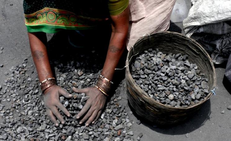 Path to riches? A woman rummages through mining overburden in search of left-over coal to sell at Jugsalai, Jharkhand. India. Photo: Akshay Mahajan via Flickr (CC BY-NC-SA).