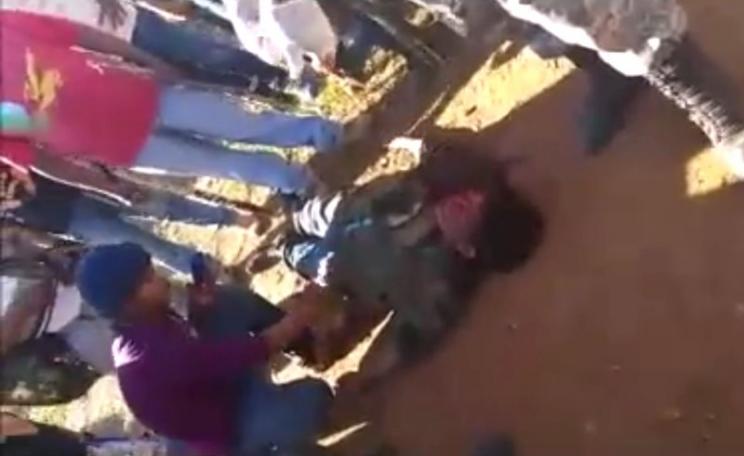 Guarani man Semião Vilhalva lies on the ground, murdered by ranchers' gunmen last weekend. Photo: still from video by Marcelo Zelic via Facebook.