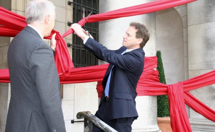 Grant Shapps MP cutting away at 'red tape' to demonstrate the government's commitment to corporate deregulation no matter what the cost to health, safety and environment. Photo: Department for Communities and Local Government via Flickr (CC BY-ND).
