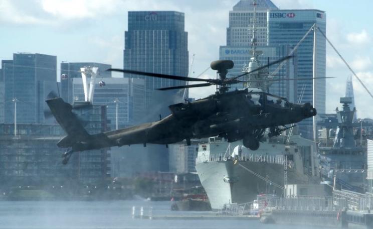 Finance and terror, war and profit: never far apart. A US army helicopter hovers over Royal Victoria Dock, away from the DESI 2015 arms fair at the ExCeL Centre, 19th September 2015. Photo: Matt Buck via Flickr (CC BY-SA).