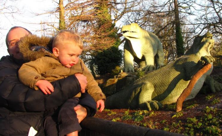 Two individuals of a fearsome species that's inflicting mass extinction on our planet, and (right) a couple of harmless Victorian dinosaurs at Crystal Palace Park, South London. Photo: London looks via Flickr (CC BY).