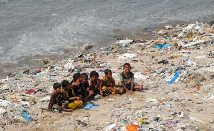 Children playing on a 'plastic beach' at the mouth of Versova Creek near Mumbai - an area formerly home to large tracts of mangroves and Great Egrets. Photo: Ravi Khemka via Flickr (CC BY).