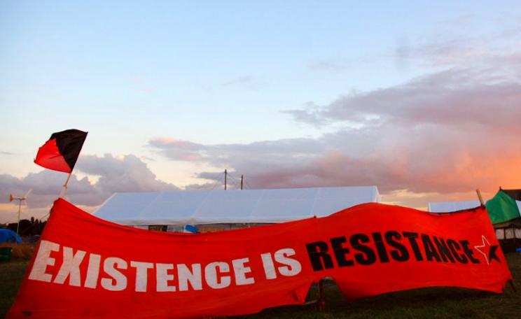'Existence is Resistance!' Banner at the Climate Camp in Sipson village, wjhich wold be entirely destroyed by a third Heathrow runway, 16th August 2007. Photo: Alice via Flickr (CC BY-NC-ND).