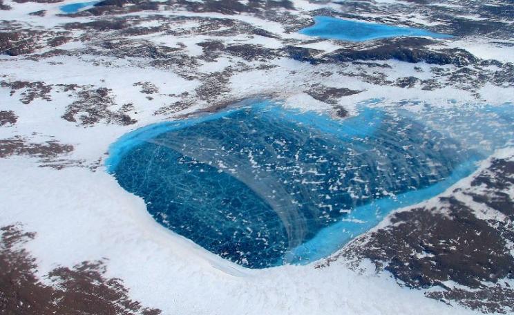 Frozen meltwater lake along the northeast Greenland coast, as seen from NASA's P-3B aircraft on May 7, 2012. Photo: Jim Yungel / NASA Goddard Space Flight Center via Flickr (CC BY).