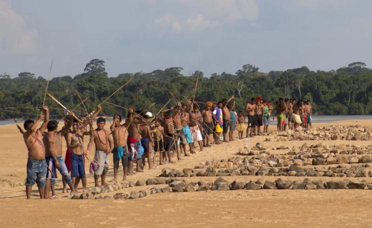 Greenpeace activists and Munduruku Indians protest on a sandy beach on the banks of the Tapajos river, near Itaituba, Pará, where the government plans to build the first of a series of five dams. Photo: Greenpeace Brazil via Flickr (CC BY).