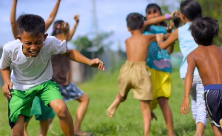 How will the promoters of GMO golden rice ensure that malnourished children receive it in the first place? Will they also ensure they get the dietary fat they need to actually assimilate the carotene once they have eaten it? Photo of children playing in M