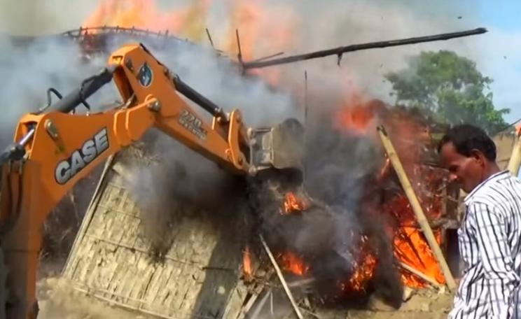 A village being destroyed with fire, bulldozers and elephants as the Kaziranga Reserve doubles in size into local farmland and settlements. Photo: still from video by BBC Newsnight.