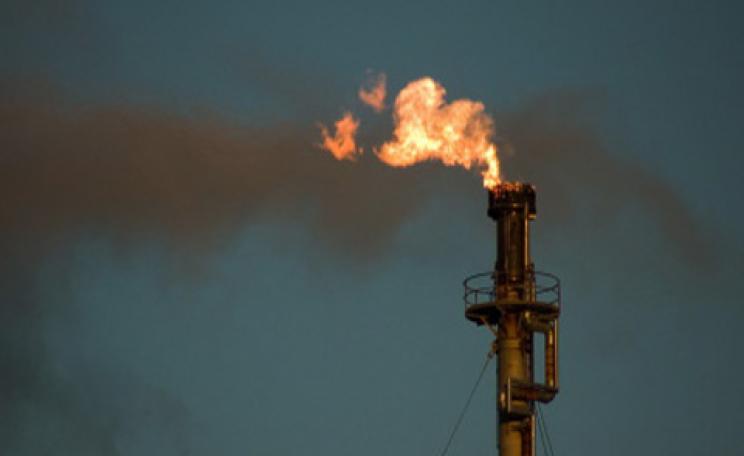 A flare burns waste gas at an oil refinery