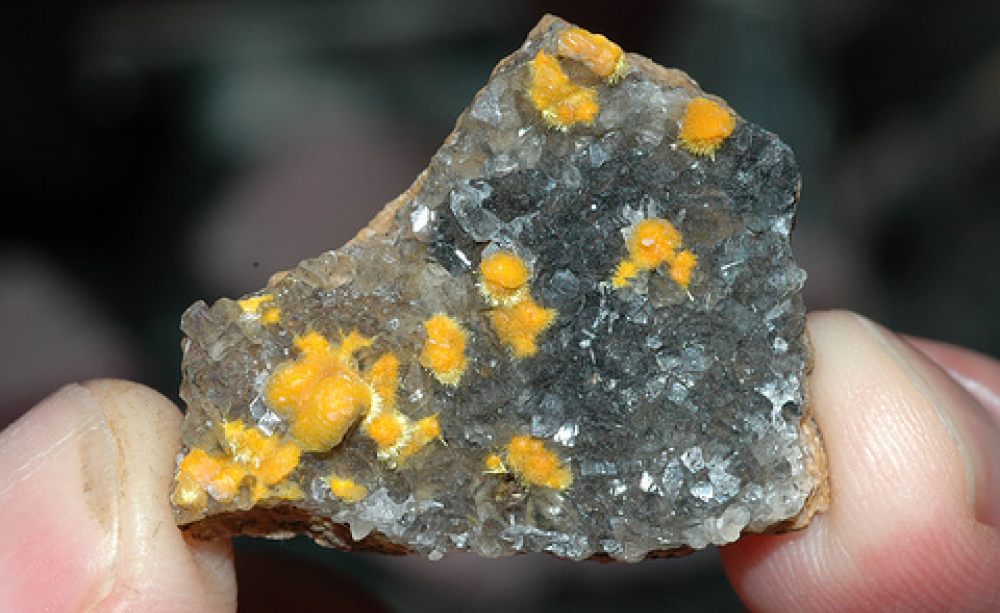Calcite with boltwoodite encrustations from the Rossing uranium mine in Namibia. Photo:  Striving to a goal via Flickr.com.