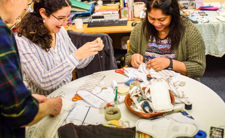 Photograph of women at a workshop making reusable menstrual pads