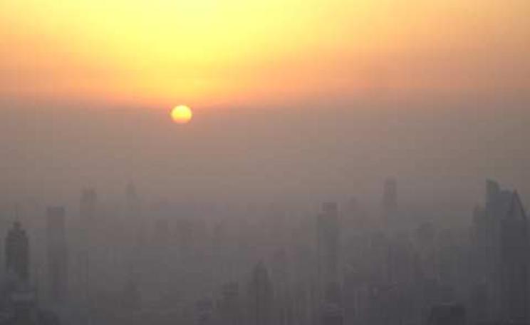 Shanghai at sunset seen from the Jin Mao tower observation deck. The sun has not yet dropped below the horizon; it has simply reached the smog line. Wikimedia commons / Suicup.