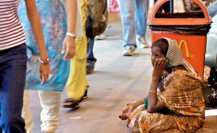 CDC's development model in microcosm? Girl begging outside McDonalds outlet, India. Photo: Jon Ardern via Flickr (CC BY-NC-SA).