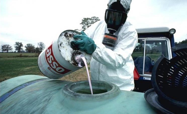 Monsanto Lasso herbicide is prepared to be sprayed on food crops.